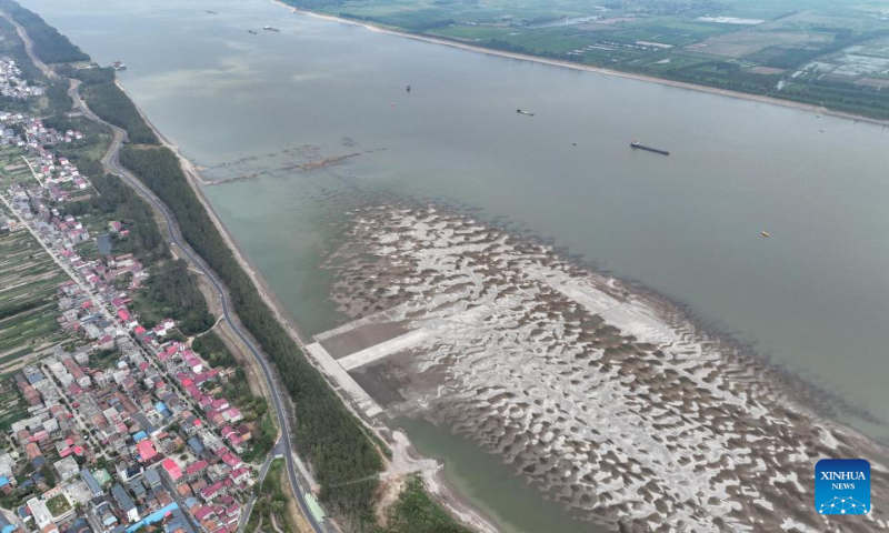 Aerial photo taken on Aug. 24, 2022 shows a section of the Yangtze River in Chaisang District of Jiujiang City, east China's Jiangxi Province. Due to continuous high temperature and less rainfall, the water level of Yangtze River in some parts of Jiujiang City has fallen significantly. Jiangxi Province on Wednesday raised its drought emergency response from Level IV to Level III starting from 10 a.m. as the drought continues. (Xinhua/Zhou Mi) 