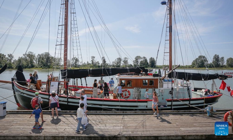 People visit a wooden boat during the 19th annual Richmond Maritime Festival in Richmond, British Columbia, Canada, on Aug. 20, 2022.Photo:Xinhua