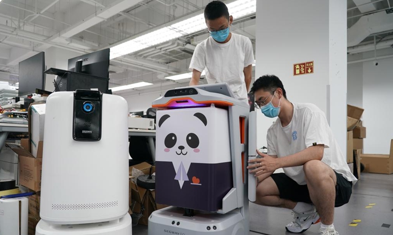 Engineers of a service robot company set up a service robot at Zhongguancun Dongsheng science park in Haidian District of Beijing, capital of China, Aug. 15, 2022.Photo:Xinhua