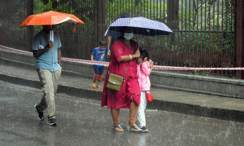 People walk in heavy rain in Bangalore, India, Aug. 21, 2022.Photo:Xinhua