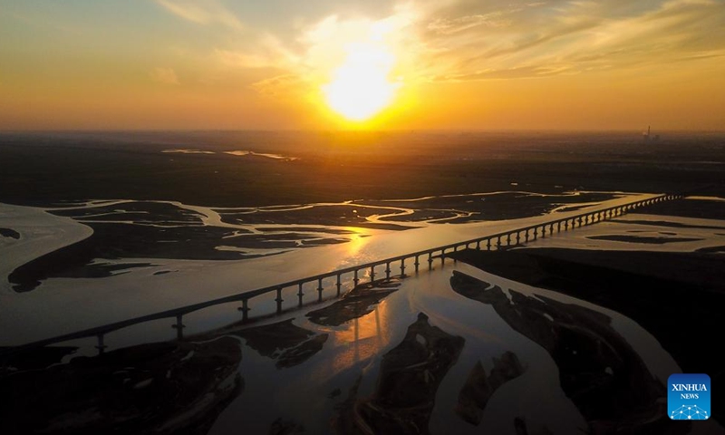 Aerial photo taken on Aug. 16, 2022 shows the sunset above the Yellow River in Hanggin Banner in Erdos, north China's Inner Mongolia Autonomous Region.Photo:Xinhua