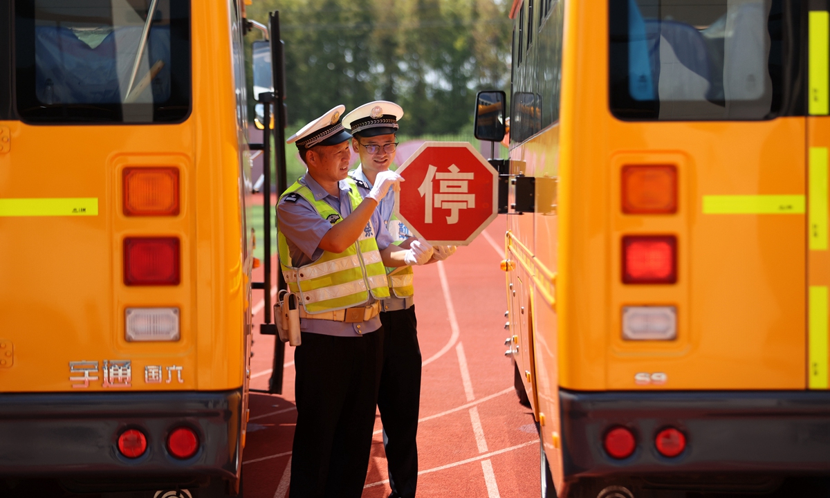 Police in Huzhou, East China's Zhejiang Province conduct safety inspections of a school bus on August 22, 2022, focusing on the performance of the bus and its condition, as well as its safety facilities, to ensure the safety of students in the upcoming new semester. Photo: VCG