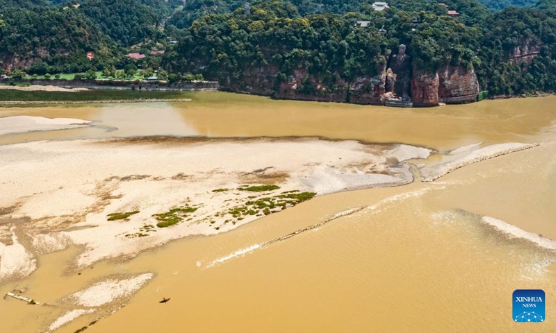 Aerial photo taken on Aug. 23, 2022 shows the exposed base of the Leshan Giant Buddha in southwest China's Sichuan Province. Facing the confluence of the Minjiang, Dadu and Qingyi rivers which saw the decrease of water level in recent days due to continuous high temperature, the base of the Leshan Giant Buddha became exposed above the water.(Photo: Xinhua)