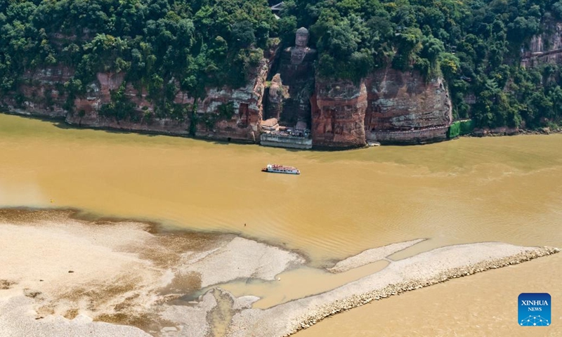 Aerial photo taken on Aug. 23, 2022 shows the exposed base of the Leshan Giant Buddha in southwest China's Sichuan Province. Facing the confluence of the Minjiang, Dadu and Qingyi rivers which saw the decrease of water level in recent days due to continuous high temperature, the base of the Leshan Giant Buddha became exposed above the water.(Photo: Xinhua)