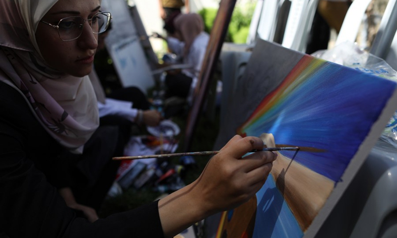 Palestinian artists are painting to commemorate the deceased artist Donyana al-Amour at her house in the southern Gaza Strip city of Khan Younis, on Aug. 23, 2022.(Photo: Xinhua)