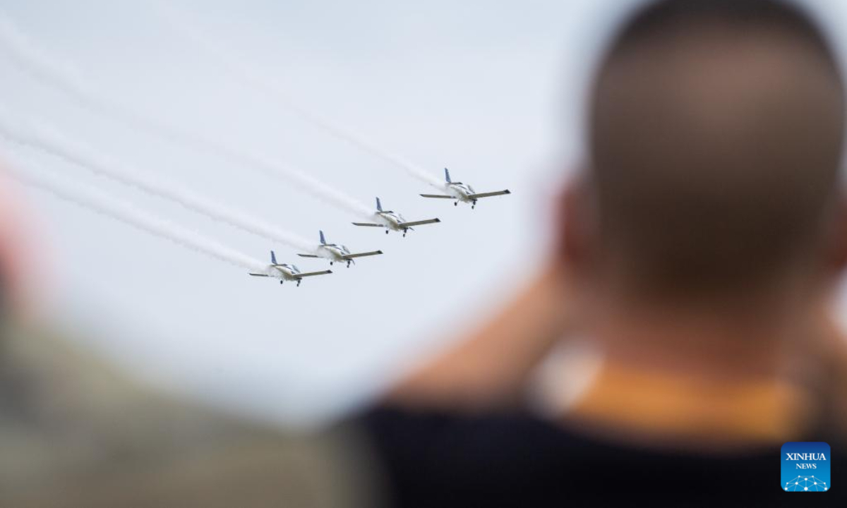 Visitors watch a performance of fixed-wing aircraft during an air show, which is a part of the 2022 Hunan (International) General Aviation Industry Expo, at the Lusong Airport of Zhuzhou City, central China's Hunan Province, Sep 1, 2022. Photo:Xinhua