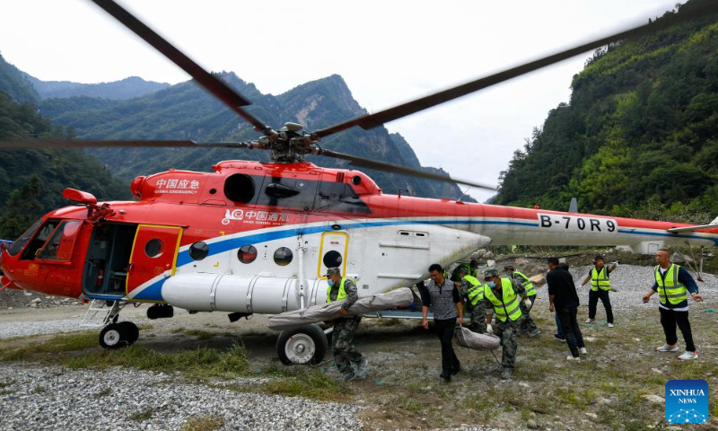 Villagers carry relief supplies sent by a helicopter in Caoke township of Shimian county, Southwest China's Sichuan Province, September 7, 2022. Photo: Xinhua