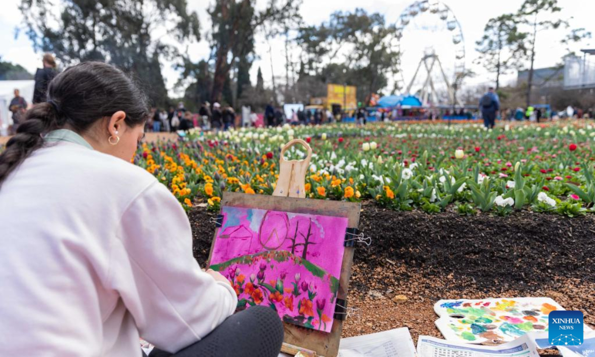 A visitor paints a picture at the festival event of Floriade in the Commonwealth Park in Canberra, Australia, Sep 17, 2022. Floriade, one of the Australian Capital Territory's signature events, opened in the Commonwealth Park on Saturday for the first time in three years with the theme Sounds of Spring. Hundreds of thousands of people are expected to flood into the festival event. Photo:Xinhua