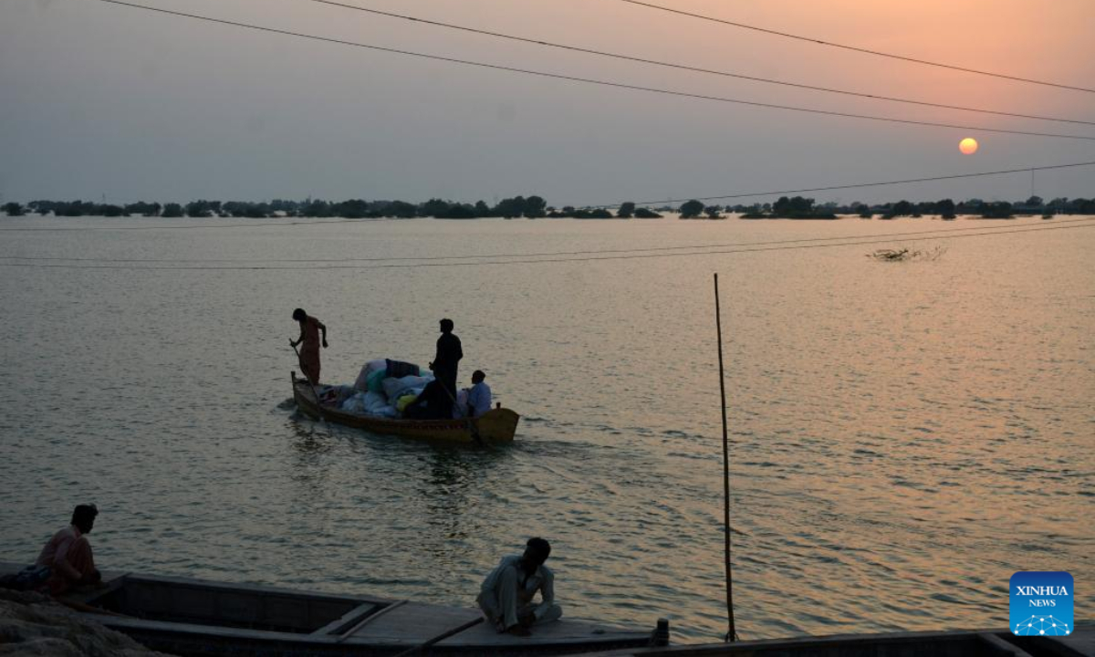 People row boats on flood water in Jamshoro district, Sindh province, Pakistan, Sept. 15, 2022. At least 22 people were killed and nine others injured in heavy monsoon rain-triggered flash floods in the last 24 hours in Pakistan, the National Disaster Management Authority (NDMA) said. Photo:Xinhua