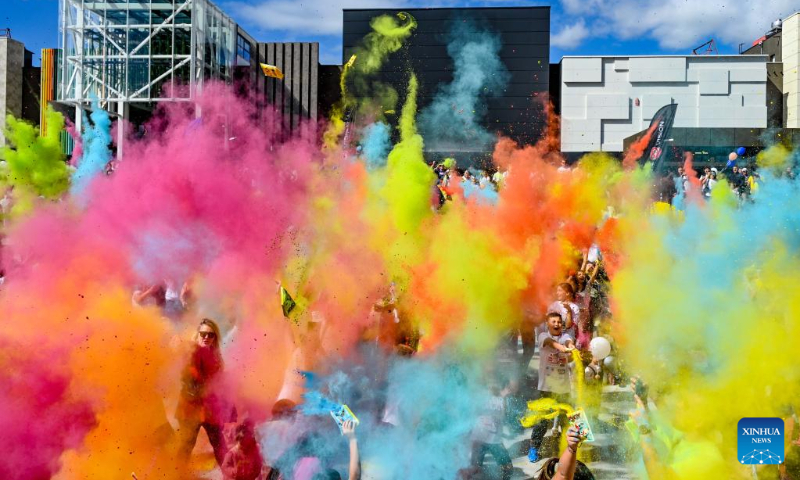 People throw color and dance after they finished the color run in Skopje, North Macedonia, Sept. 18, 2022. (Photo by Tomislav Georgiev/Xinhua)