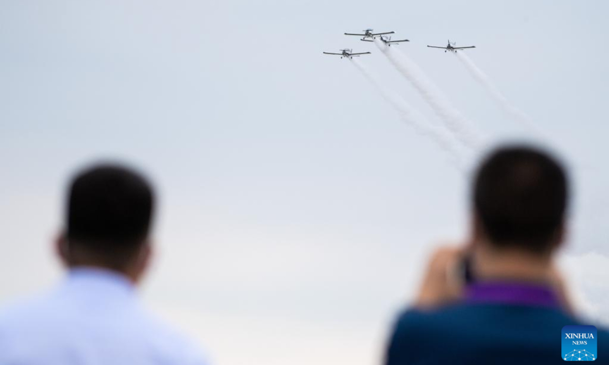 Visitors watch a performance of fixed-wing aircraft during an air show, which is a part of the 2022 Hunan (International) General Aviation Industry Expo, at the Lusong Airport of Zhuzhou City, central China's Hunan Province, Sep 1, 2022.Photo:Xinhua