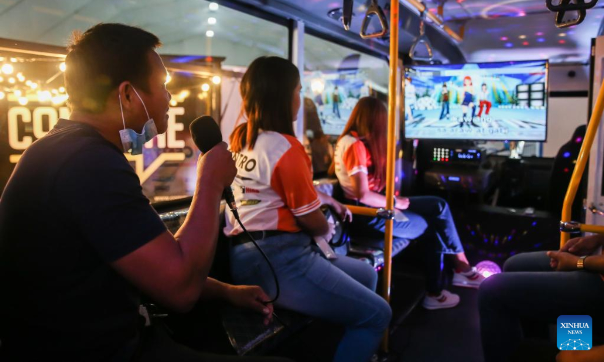 People sing along using a karaoke installed inside a concept modern public utility jeepney at the Philippine International Motor Show in Pasay City, the Philippines, Sep 17, 2022. Photo:Xinhua