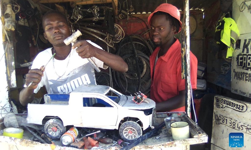 Young men assemble toy cars at a workshop in Opuwo town, Kunene region, Namibia, on Aug. 30, 2022. Young street engineers from Opuwo town in Kunene region, north-western Namibia, are integrating robotics into hand-made toy cars to capture new business opportunities.(Photo: Xinhua)