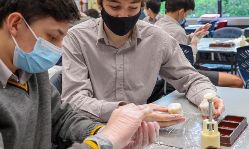 Students make moon cakes at a Chinese class to celebrate the upcoming Mid-Autumn Festival at a school in Wellington, New Zealand, Sept. 5, 2022. (China Cultural Centre in Wellington/Handout via Xinhua)