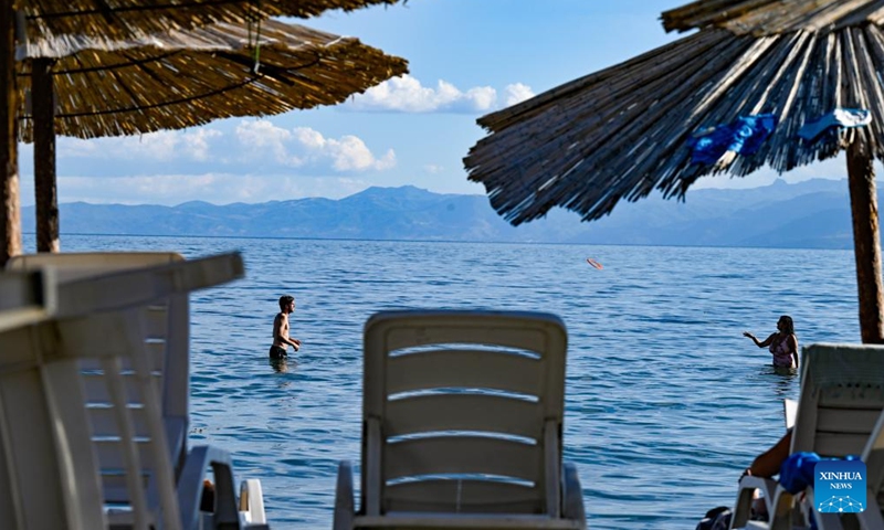 People spend time in the water of Ohrid Lake in Struga, North Macedonia, Sept. 3, 2022.Photo:Xinhua