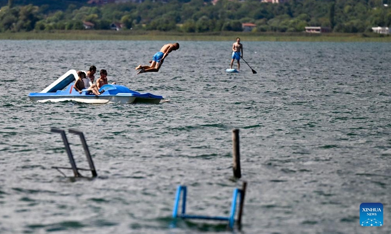 People spend time in the water of Ohrid Lake in Struga, North Macedonia, Sept. 3, 2022.Photo:Xinhua