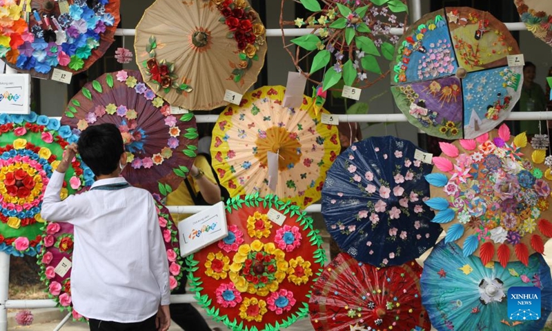 A boy watches traditional umbrellas displayed during the Indonesia Umbrella Festival at Pura Mangkunegaran in Surakarta, Central Java, Indonesia, Sept. 4, 2022.Photo:Xinhua