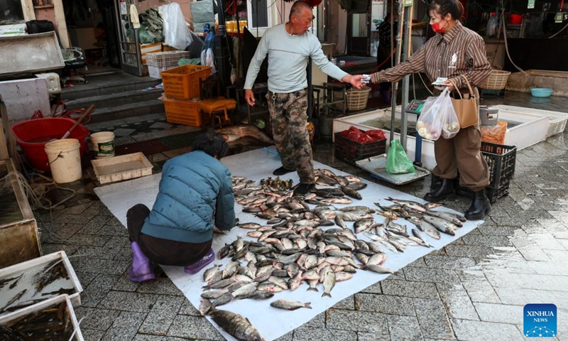 A citizen buys fish at Dongji fish market, literally means the easternmost fish market, in Fuyuan City, northeast China's Heilongjiang Province, Sept. 4, 2022.(Photo: Xinhua)