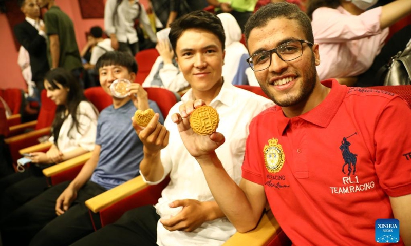 Egyptian and Chinese students take photos with mooncakes at a Mid-Autumn Festival celebration in Cairo, Egypt, Sept. 8, 2022.(Xinhua/Ahmed Gomaa)