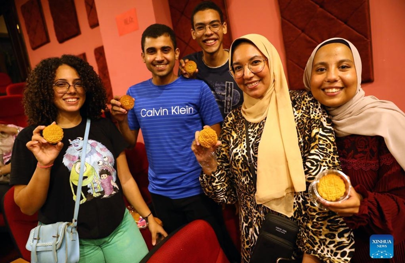 Students take photos with mooncakes at a Mid-Autumn Festival celebration in Cairo, Egypt, Sept. 8, 2022.(Xinhua/Ahmed Gomaa)