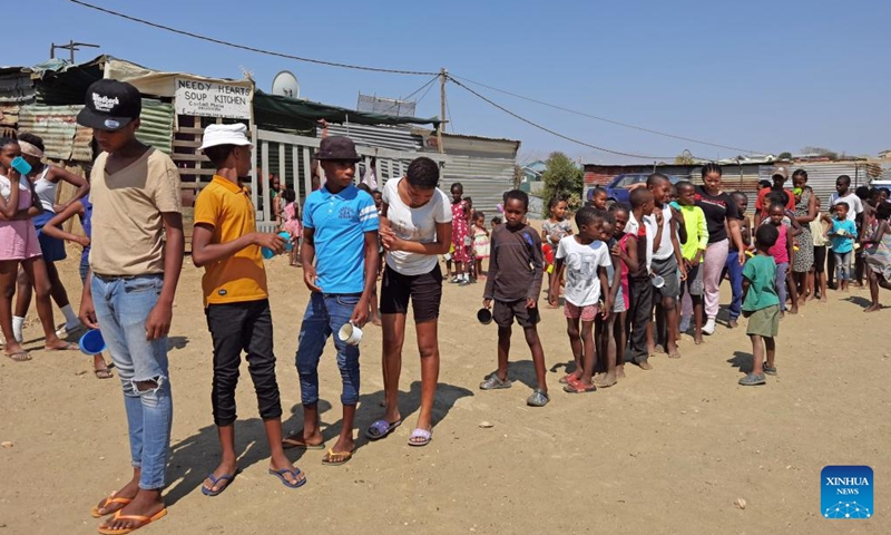 Children line up to receive food at Needy Hearts Soup Kitchen in Hakahana, an informal settlement in Windhoek, Namibia, on Sept. 12, 2022.Photo:Xinhua