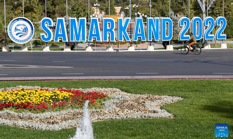 A man rides past a logo of the 22nd meeting of the Council of Heads of State of the Shanghai Cooperation Organization (SCO) in Samarkand, Uzbekistan on Sept. 12, 2022. The 22nd meeting of the Council of Heads of State of the SCO will be held in Samarkand.(Photo: Xinhua)