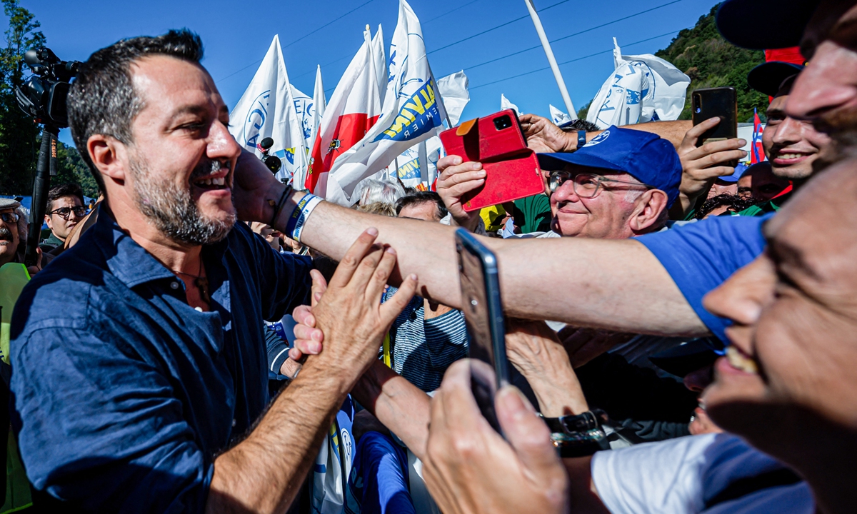 Supporters cheer as party leader Matteo Salvini (left) arrives to speak on stage on September 18, 2022 during the annual meeting of the League party (Lega) in Pontida, northern Italy, ahead of the September 25 general election. The party has put anti-immigrant rhetoric at the heart of its campaign. Photo: AFP