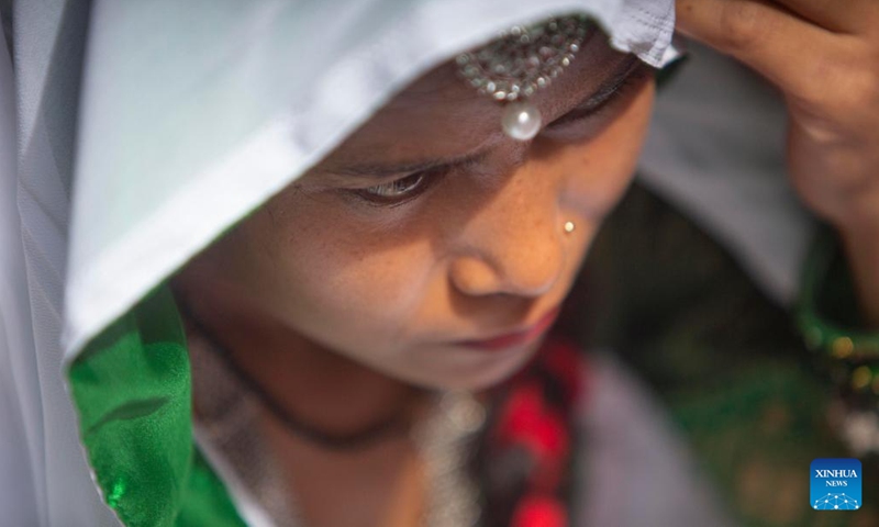 A woman in traditional attire offers a prayer during the Jitiya festival in Kathmandu, Nepal, Sept. 18, 2022. The Jitiya festival is mostly celebrated by married women from the Tharu community for the well-being of their husbands and sons by observing a fast without water. (Photo by Sulav Shrestha/Xinhua)


