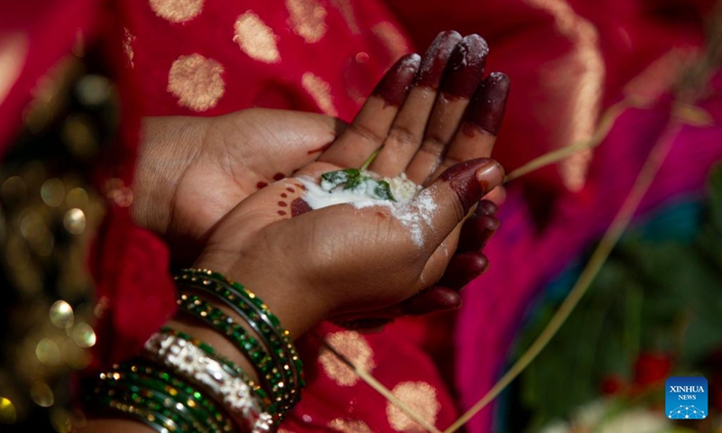 A woman in traditional attire offers a prayer during the Jitiya festival in Kathmandu, Nepal, Sept. 18, 2022. The Jitiya festival is mostly celebrated by married women from the Tharu community for the well-being of their husbands and sons by observing a fast without water. (Photo by Sulav Shrestha/Xinhua)


