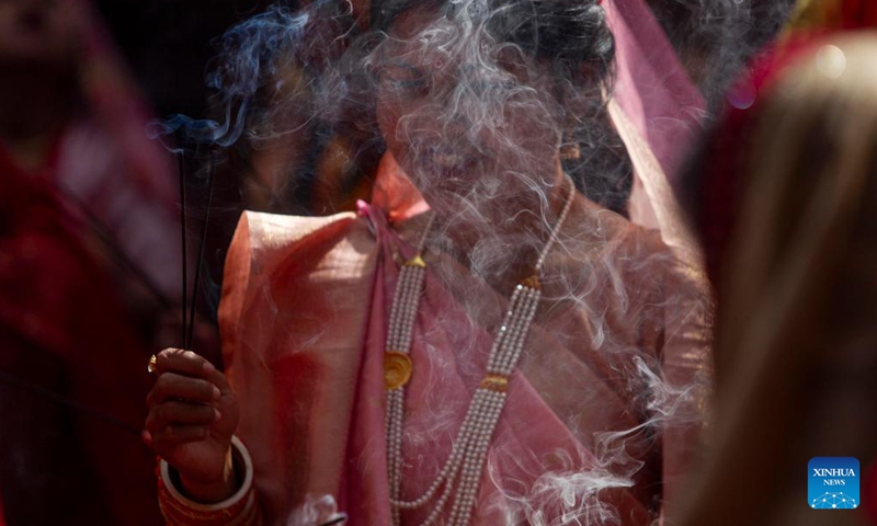 A woman in traditional attire offers a prayer during the Jitiya festival in Kathmandu, Nepal, Sept. 18, 2022. The Jitiya festival is mostly celebrated by married women from the Tharu community for the well-being of their husbands and sons by observing a fast without water. (Photo by Sulav Shrestha/Xinhua)


