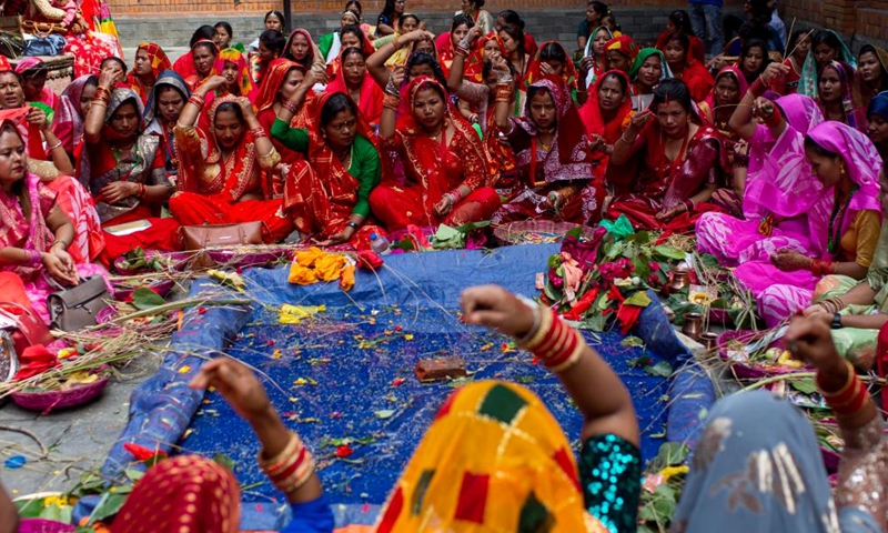 Women in traditional attire offer prayers during the Jitiya festival in Kathmandu, Nepal, Sept. 18, 2022. The Jitiya festival is mostly celebrated by married women from the Tharu community for the well-being of their husbands and sons by observing a fast without water. (Photo by Sulav Shrestha/Xinhua)


