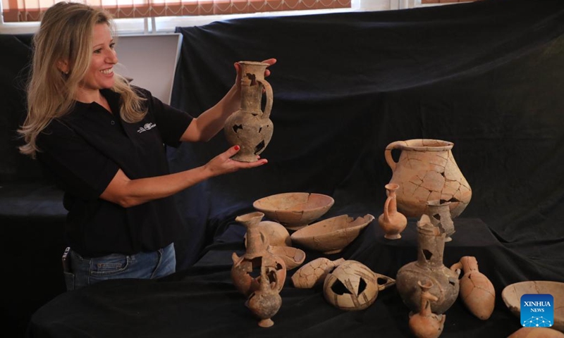 An archeologist shows a pottery vessel in which opium remains were found, in Jerusalem, on Sept. 20, 2022.(Photo: Xinhua)