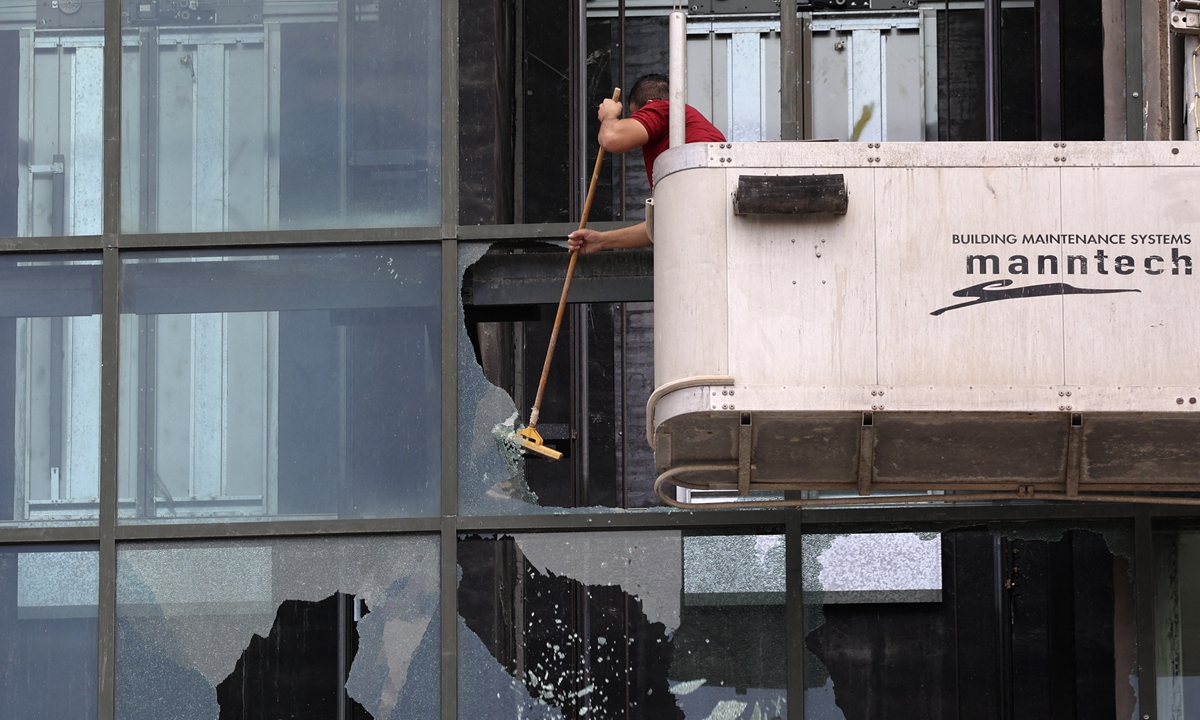 Shattered windows are repaired as calm returns to the West Bank city of Nablus, Palestine, following clashes between protesters and Palestinian security forces the previous day, on September 21, 2022. Photo: AFP