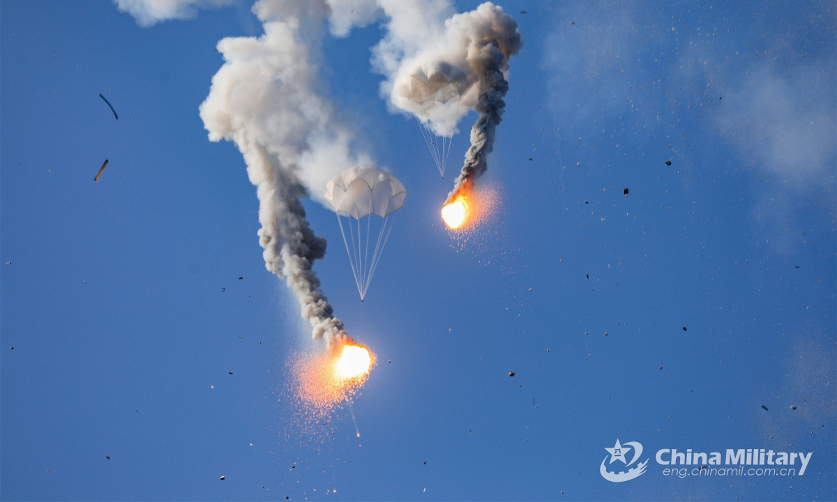 Decoy flares hanging under the parachutes descend slowly in the air during an all-subject training assessment organized by a naval frigate flotilla under the PLA Southern Theater Command on September 5, 2022. Photo:China Military