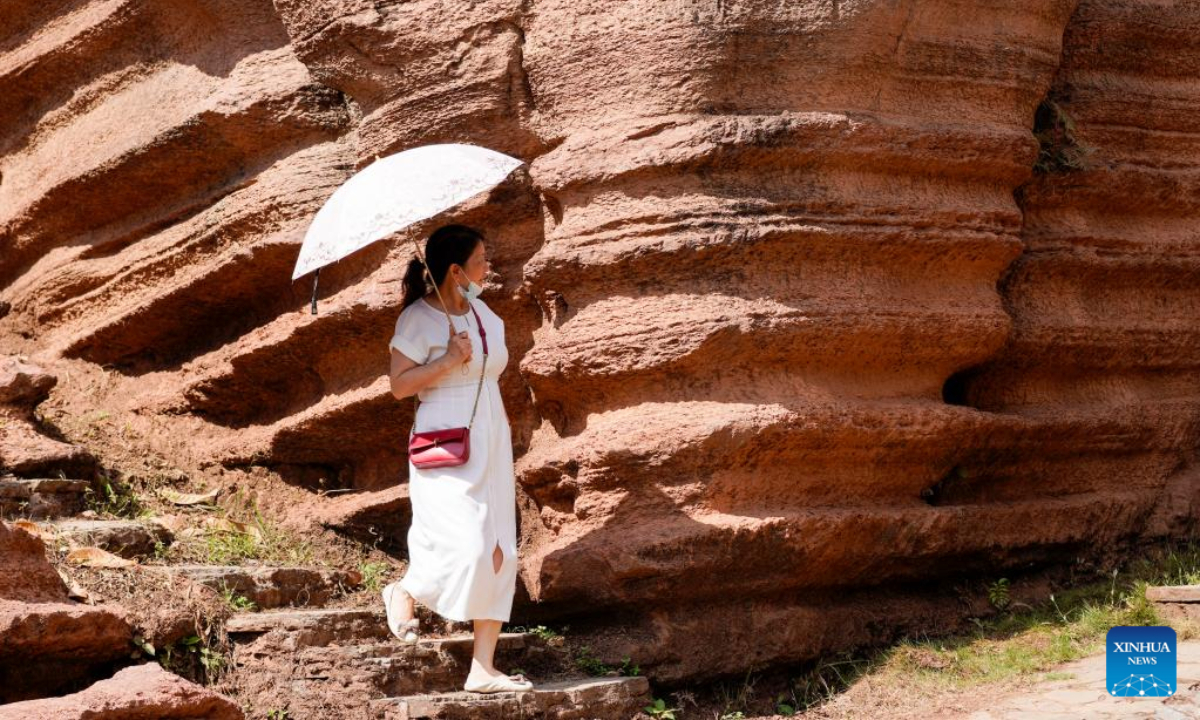 A tourist visits a red stone forest geopark in Youyang Tujia and Miao Autonomous County, southwest China's Chongqing Municipality, Oct. 3, 2022. The Youyang red stone forest geopark, which has the karst landform, opened to the public during the National Day holiday. Photo:Xinhua