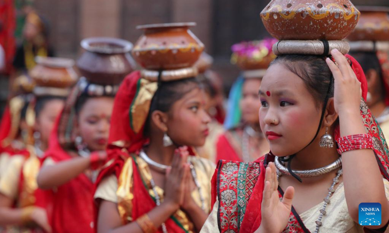 Girls in traditional attire perform during a celebration for the World Tourism Day at Patan Durbar Square in Lalitpur, Nepal, Sept. 27, 2022. (Photo by Sulav Shrestha/Xinhua)