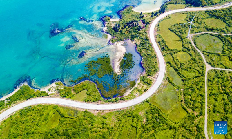 Aerial photo taken on Oct. 6, 2022 shows a view of a scenic coastal highway in Danzhou, south China's Hainan Province. (Xinhua/Pu Xiaoxu)