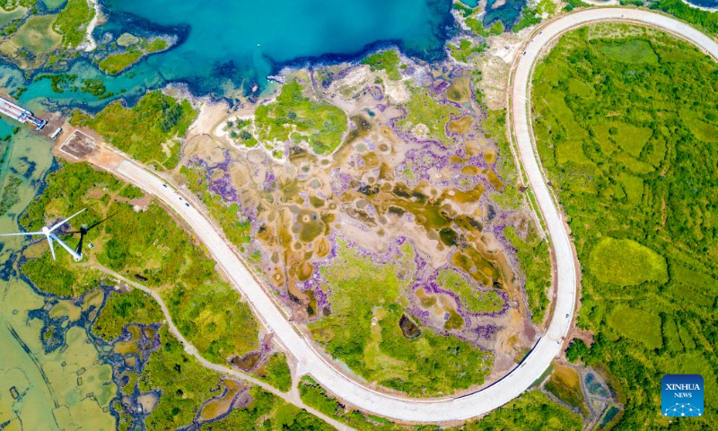 Aerial photo taken on Oct. 6, 2022 shows a view of a scenic coastal highway in Danzhou, south China's Hainan Province. (Xinhua/Pu Xiaoxu)