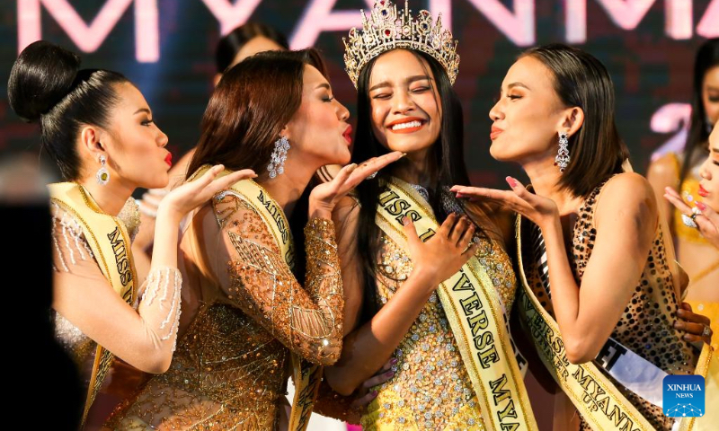 Zar Li Moe (C), after winning the crown of Miss Universe Myanmar 2022, poses with other beauty contestants in Yangon, Myanmar, Oct. 1, 2022. A total of 14 beauty contestants participated in the Miss Universe Myanmar 2022 finale in Yangon on Saturday. (Photo by Myo Kyaw Soe/Xinhua)