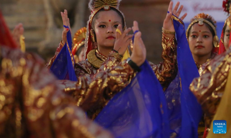 Girls in traditional attire perform during a celebration for the World Tourism Day at Patan Durbar Square in Lalitpur, Nepal, Sept. 27, 2022. (Photo by Sulav Shrestha/Xinhua)