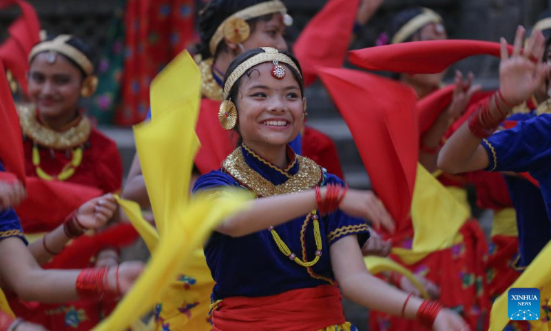 Girls in traditional attire perform during a celebration for the World Tourism Day at Patan Durbar Square in Lalitpur, Nepal, Sept. 27, 2022. (Photo by Sulav Shrestha/Xinhua)