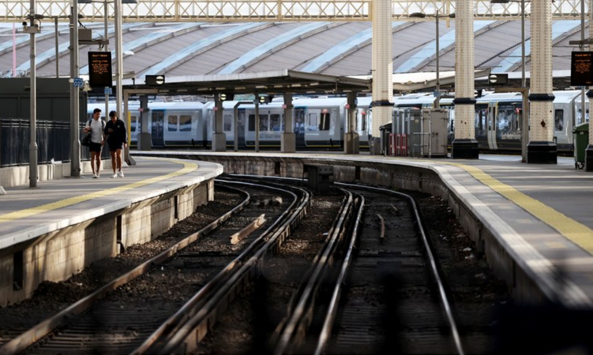 People walk next to the railways in Waterloo Station in London, Britain, on Aug 20, 2022. Photo:Xinhua