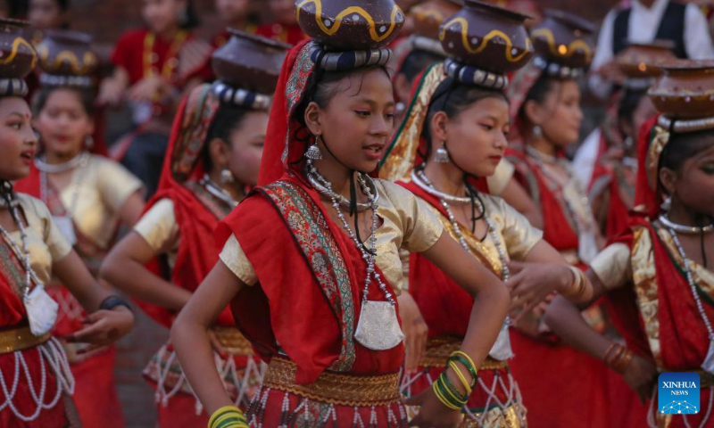 Girls in traditional attire perform during a celebration for the World Tourism Day at Patan Durbar Square in Lalitpur, Nepal, Sept. 27, 2022. (Photo by Sulav Shrestha/Xinhua)