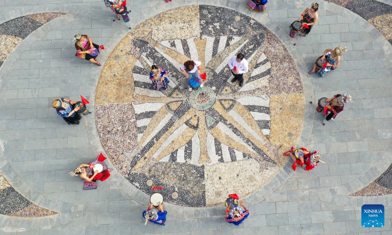 Aerial photo taken on Oct. 1, 2022 shows people playing drums in Zaojiaoping Subdistrict of Yuping Dong Autonomous County of Tongren, southwest China's Guizhou Province. (Photo by Hu Panxue/Xinhua)