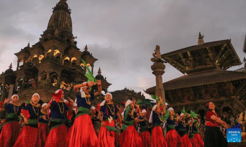 Girls in traditional attire perform during a celebration for the World Tourism Day at Patan Durbar Square in Lalitpur, Nepal, Sept. 27, 2022. (Photo by Sulav Shrestha/Xinhua)