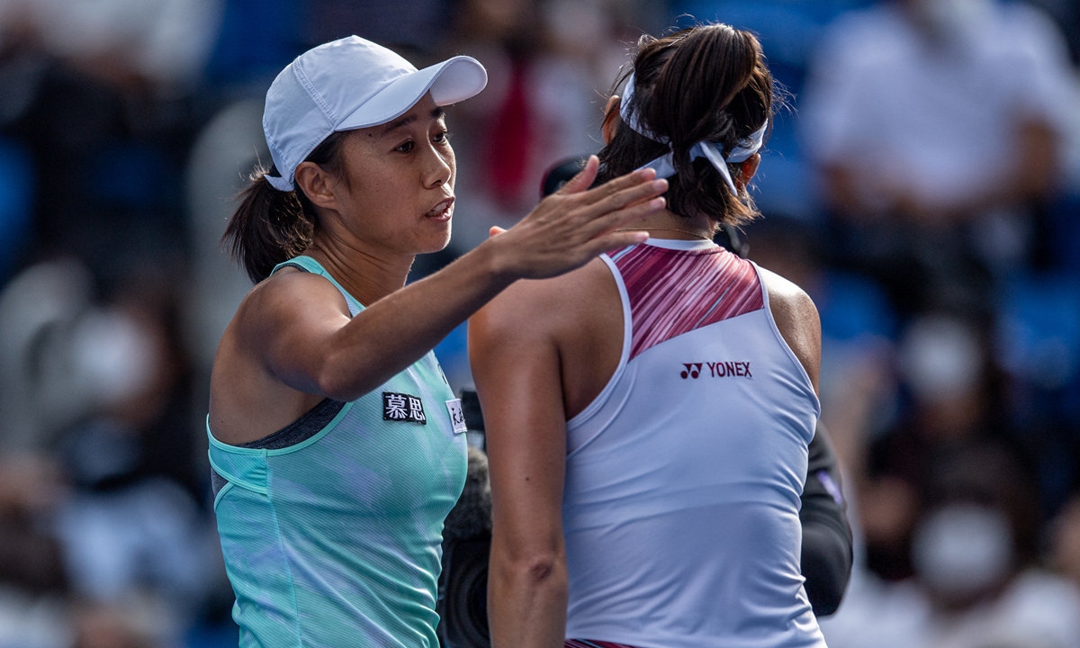 Zhang Shuai of China (left) celebrates her victory against Caroline Garcia of France during their women's singles match in Tokyo, Japan on September 21, 2022. Photo: AFP