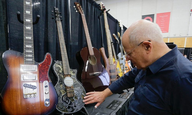 A visitor views guitars at the Vancouver International Guitar Festival in Vancouver, Canada, on Sept. 24, 2022.Photo:Xinhua