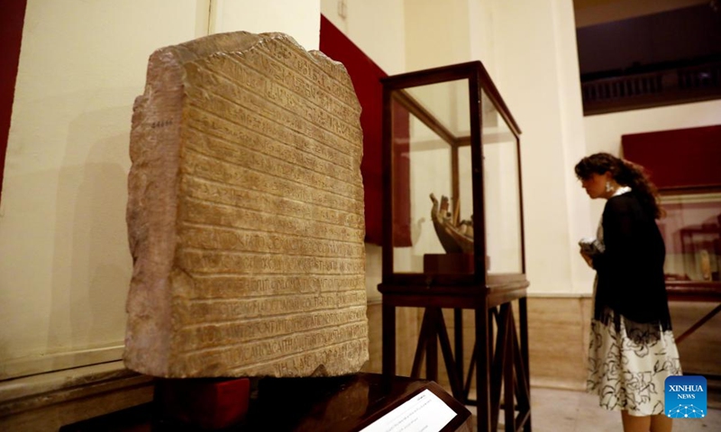 A woman views ancient Egyptian artifacts at a temporary exhibition of antiquities at Egyptian Museum in Cairo, Egypt, on Sept. 27, 2022. The Egyptian Museum on Tuesday opened a temporary exhibition of antiquities to mark World Tourism Day, which coincides this year with the 200th anniversary of the creation of the field of Egyptology and the decoding of ancient hieroglyphs.(Photo: Xinhua)