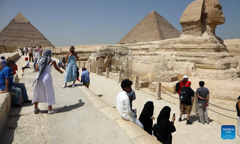 Tourists visit Sphinx at the Giza Pyramids scenic spot during the World Tourism Day in Giza, Egypt, Sept. 27, 2022. Egypt on Tuesday opened most of its museums and archaeological sites, including the Giza Pyramids, to visitors for free on the occasion of the World Tourism Day.(Photo: Xinhua)