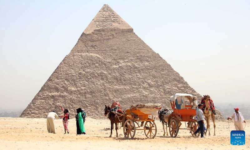 Tourists visit the Giza Pyramids scenic spot during the World Tourism Day in Giza, Egypt, Sept. 27, 2022. Egypt on Tuesday opened most of its museums and archaeological sites, including the Giza Pyramids, to visitors for free on the occasion of the World Tourism Day.(Photo: Xinhua)